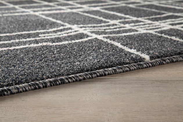 The Jai rug’s abstract pattern is certainly a sight for sore eyes. Spindled cross hatching pops off the muted black in a fun, casual-cool finish. Rest assured, machine woven polypropylene is built to last through guests, children and whatever else life throws your way.Made of polypropylene | Machine woven | 8mm pile | Jute backing | Rug pad recommended | Spot clean only | Imported