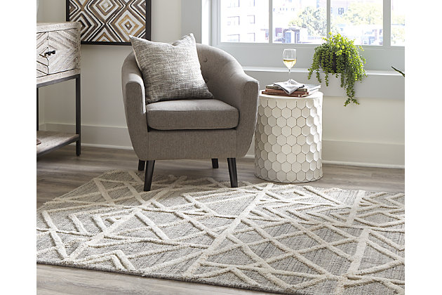 Dynamic geometric shapes coupled with subtle neutral colors communicate sophistication even when underfoot. The Karah area rug works as well in a transitional suburban space as it does in an ultra-modern loft. Sink your toes into something more cosmopolitan.Made of wool | Handwoven | 12mm pile | Cotton backing | Due to the use of natural materials, some variation may occur | Rug pad recommended | Spot clean only | Imported