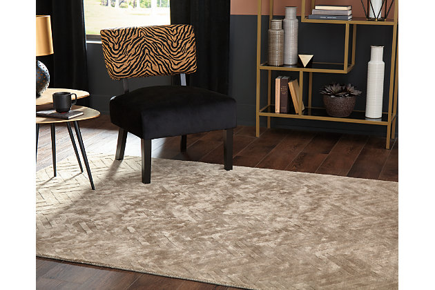 For a soft, modern look, cover your floor with the Kanella area rug. Hand loomed and carved, this floor covering offers casual style in an easy way with a gold chevron design made to fit into many interiors.Made of viscose | Hand loomed | Carved design | Cotton backing | Rug pad recommended | Spot clean only | Imported