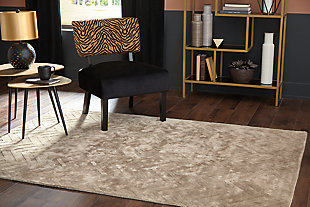 For a soft, modern look, cover your floor with the Kanella area rug. Hand loomed and carved, this floor covering offers casual style in an easy way with a gold chevron design made to fit into many interiors.Made of viscose | Hand loomed | Carved design | Cotton backing | Rug pad recommended | Spot clean only | Imported