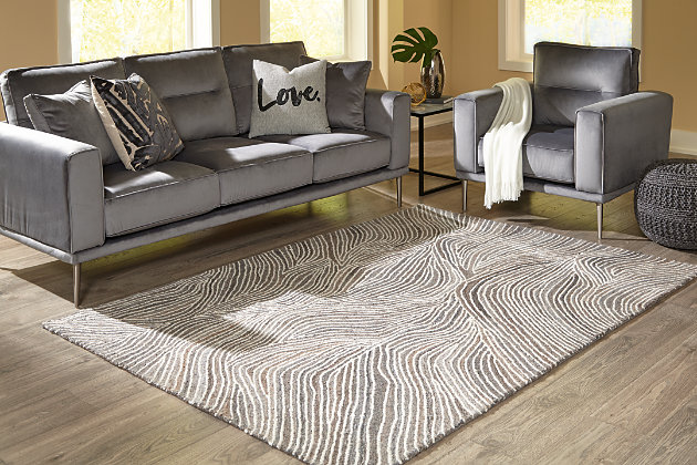 Refreshingly simple, the Wysleigh hand-tufted abstract accent rug adds contemporary elegance to your home. The gray, brown and ivory color palette is pleasing to the eye and perfect for any room.Made of wool/polyester blend | Backed with cotton | Abstract design | Hand-tufted | Medium pile | Spot clean | Rug pad recommended | Imported