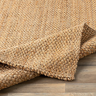 Dress up any floor with the natural hue and designer look of this rug. It welcomes visitors with warmth and comfort underfoot. Neutral color palette exudes a relaxed sensibility which works wonders in any decor.Made of jute | Handwoven | No pile | No backing; rug pad recommended | Spot clean | Imported
