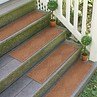 Step up to a higher level of comfort, safety and quality with this set of four Aqua Shield stair treads. Beyond scraping dirt from shoes and paws, these stylish stair treads have an exclusive “water dam” design for unbeatable absorbency. Resistant to the most extreme weather elements, they're certified slip resistant by the National Floor Safety Institute—making them the ultimate way to go inside and out!Set of 4 | 100% polypropylene face is anti-static, quick drying and resistant to the most extreme weather elements, including intense sunlight | Synthetic rubber underside keeps stair treads in place though stair tread installation tape is highly recommended | Permanently molded design will not crush mildew, mold, or rot | Low-profile design allows door to swing over the treads without catching | Suitable for indoor/outdoor use | Sweep, vacuum or hose clean | Skid-resistant synthetic rubber backing is made with 25% recycled rubber | Made in the u.s.a.
