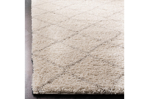 Indulge in retro revival with this sumptuous shag rug with subtle geometric design. Plush pile is loaded with fun, feel-good texture. Harmonious hues make it a tasteful choice for so many spaces.Made of polypropylene | Machine woven |  pile | No bac; rug pad recommended | Spot clean | Imported