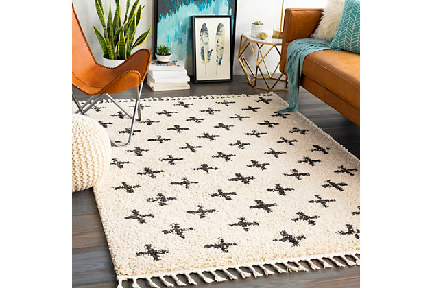 Dress up any floor with the bold pattern and vibrant feel of this tribal area rug. It welcomes visitors with warmth and comfort underfoot and graces your living space with global flair.Made of polypropylene | Machine woven | Plush pile | Imported | Spot clean only