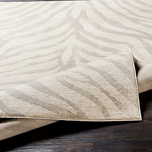 Go wild—within reason—with this subtle animal print rug. Thanks to its neutral color palette, this area rug plays nicely with other hues and can easily be placed on top of carpet or a natural-tone sisal rug for a layered look.Made of polypropylene | Machine woven; medium pile | Spot clean recommended | Imported | Rug pad recommended | Imported