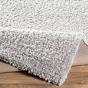 Indulge in retro revival with this sumptuous shag rug with subtle geometric design. Plush pile is loaded with fun, feel-good texture. Harmonious hues make it a tasteful choice for so many spaces.Made of polypropylene | Machine woven | Plush pile | Rug pad recommended | Spot clean recommended | Imported