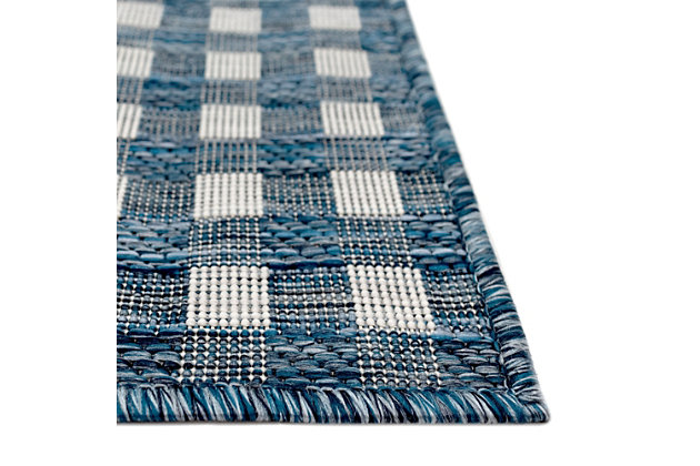 Checker it out. Equally suited to indoor and outdoor living, this checker-patterned area rug is sure to please. Neutral hues and a dynamic design deliver a home run in the style department.Made of polypropylene | Wilton woven | Uv-stabilized for indoor/outdoor use | Prolong life by limiting exposure to rain and moisture; use in a covered area | Imported | Spot clean