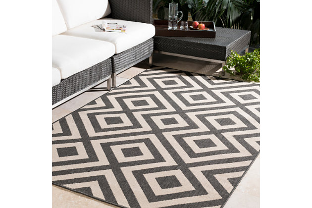 Delineate a space in a beautiful way with this designer area rug. Its gorgeous geometric design infuses a modern sensibility that simply suits your style.Made of olefin | For indoor/outdoor use | UV resistant; water resistant | Machine woven | No pile | No backing; rug pad recommended | Imported | Spot clean only