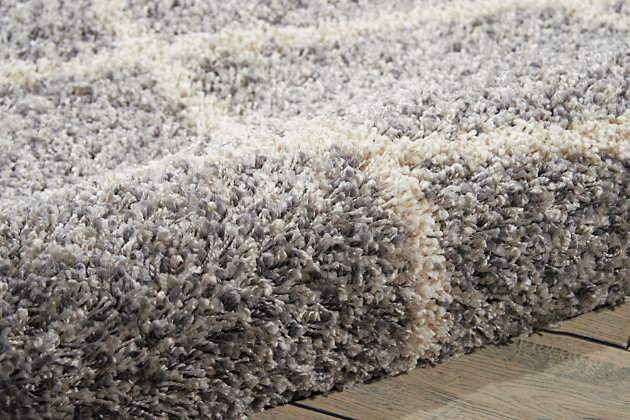 Texture and substance meet style and color with this area rug. This sensational shag is elevated with a trend-setting ash gray and ivory diamond pattern. Lavish pile makes this rug a haven for your feet. Who knew beautiful home fashion could feel so good?100% polypropylene | Machine woven | Jute backing; rug pad recommended | Imported | Spot clean