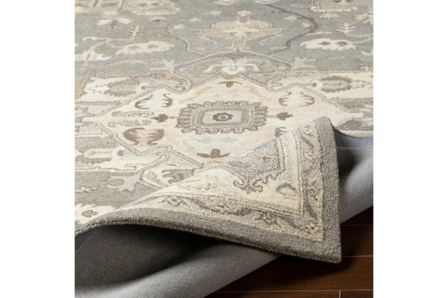 An updated interpretation of the classic medallion design, this rug delights with its fresh feel and timeless appeal. Pleasing palette grounds your space in perfect harmony.Made of wool | Hand-tufted | Medium pile | Canvas backing; rug pad recommended | Wool fibers are prone to shedding, vacuum regularly and shedding will subside | Imported | Spot clean only