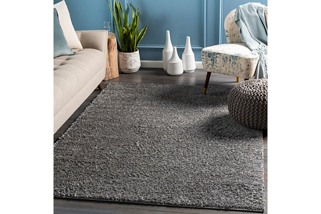 Dress up any floor with the warm hue and designer look of this rug. It welcomes visitors with warmth and comfort underfoot. Neutral color palette exudes a marvelously modern vibe which works wonders in any setting.Made of polypropylene | Machine woven | Shag pile | Rug pad recommended | Spot clean | Imported