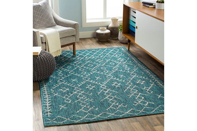 Simply timeless and beautifully on trend, this masterfully crafted Moroccan style area rug is dressed to impress. Easy elegant and casually cool, it looks right at home whether your furnishings are retro, boho or somewhere in between.Made of polypropylene | For indoor/outdoor use | UV resistant; water resistant | Machine woven | No pile | No backing; rug pad recommended | Spot clean | Imported