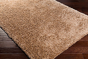 Dress up any floor with the natural hue and designer look of this rug. It welcomes visitors with warmth and comfort underfoot. Neutral color palette exudes a marvelously modern vibe which works wonders in any setting.Made of polyester | Handwoven | Shag pile | Rug pad recommended | Spot clean | Imported