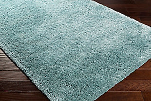 Dress up any floor with the soft hue and designer look of this rug. It welcomes visitors with warmth and comfort underfoot. A soothing color palette exudes a marvelously modern vibe which works wonders in any setting.Made of polyester | Handwoven | Shag pile | Rug pad recommended | Spot clean | Imported