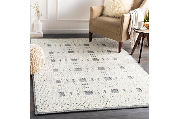 Dress up any floor with the natural hue and designer look of this rug. It welcomes visitors with warmth and comfort underfoot. Neutral color palette exudes a marvelously modern vibe which works wonders in any setting.100% wool | Hand-tufted |  pile | Rug pad recommended | Spot clean | Imported