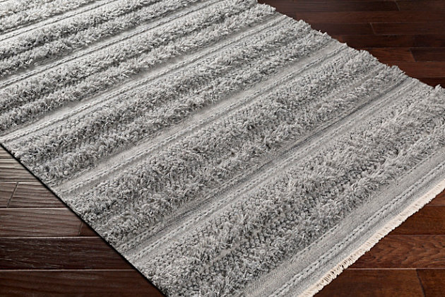 Mellow stripes and a classic color pairing make a simply striking statement. This comfortably plush area rug aligns your space in a decidedly modern way.Made of viscose and wool | Handwoven | Plush pile | Rug pad recommended | Spot clean | Imported