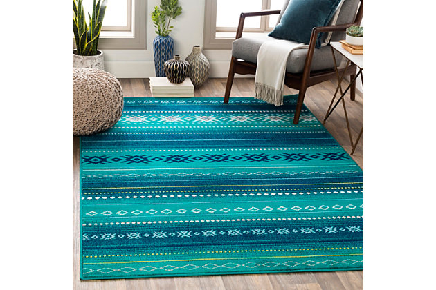 Dress up any floor with the bold hues and energetic feel of this tribal rug. It welcomes visitors with warmth and comfort underfoot. Dynamic design is sure to add interest to your living space.Made polypropylene | Machine woven | Medium pile | Rug pad recommended  | Spot clean | Imported