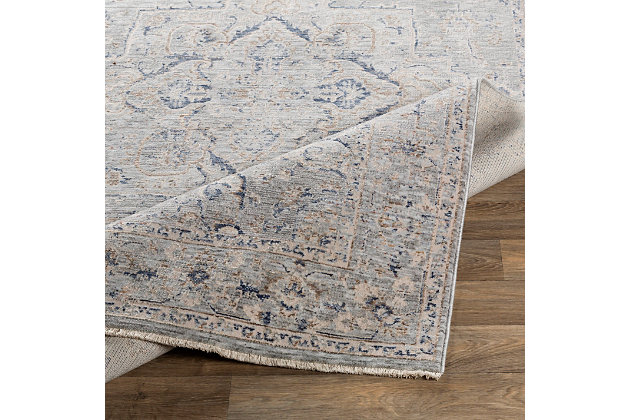 Tasteful design and harmonious hues impart a timeless look to any space. This highly versatile area rug is the perfect marriage of traditional and contemporary styles. It’s a sophisticated yet relaxed aesthetic that feels right at home.Made of polyester and viscose | Machine woven | Low pile | No backing; rug pad recommended | Spot clean | Imported