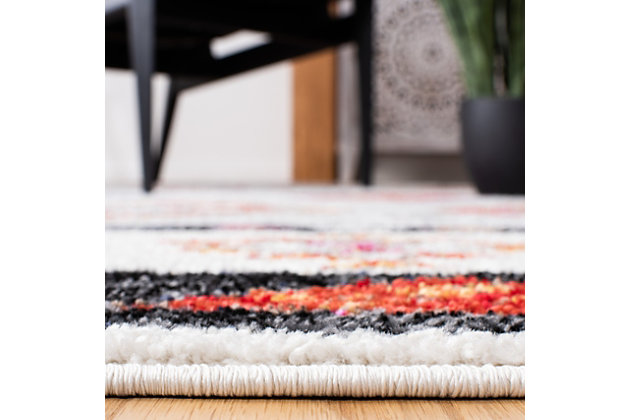 Dress up any floor with the bold hues and energetic feel of this tribal rug. It welcomes visitors with warmth and comfort underfoot. Dynamic design is sure to add interest to your living space.Made of  polypropylene | Machine woven | Medium pile | Jute backing; rug pad recommended | Spot clean | Imported