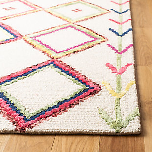 What a footloose and fancy-free feeling this rug brings to your living space. Boho-chic rug is cool and creative. Handmade craftsmanship and intricate patterns add a strikingly exotic aesthetic to your space.100% wool | Hand-tufted | Medium pile | Rug pad recommended | Spot clean | Imported