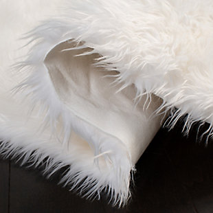 Take a walk on the wild side with this versatile faux sheepskin rug. The luxurious pile is a comfy complement to any decor. Layer on the floor, the bed or the seat of a chair for an utterly indulgent effect.Made of Japanese acrylic | Machine made | High pile | Imported | Spot clean only