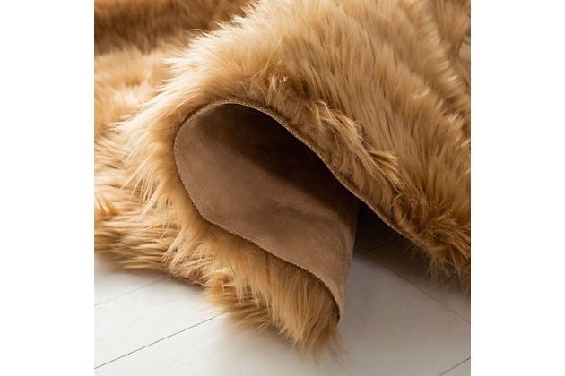 Take a walk on the wild side with this versatile faux sheepskin rug. The luxurious pile is a comfy complement to any decor. Layer on the floor, the bed or the seat of a chair for an utterly indulgent effect.Made of japanese acrylic | Machine made | High pile | Imported | Spot clean only