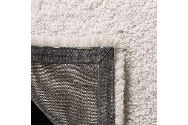 Indulge in retro revival with this sumptuous shag rug. Plush pile is loaded with fun, feel-good texture. Monochromatic hue makes it a tasteful choice for so many spaces.Made of polyester and cotton | Hand-tufted; shag pile | Rug pad recommended | Imported | Spot clean only