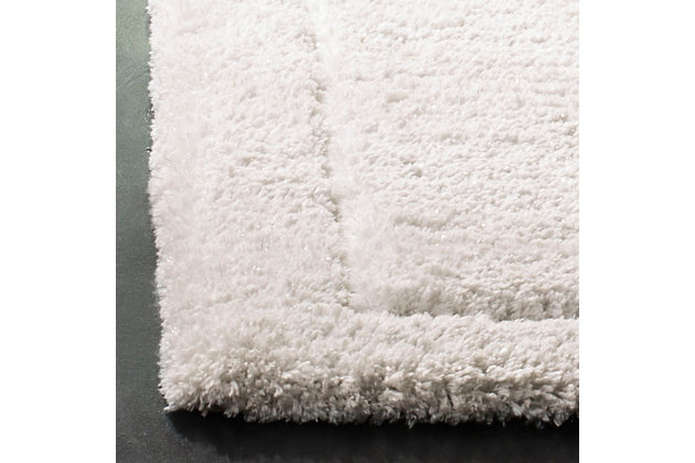 Indulge in retro revival with this sumptuous shag rug. Plush pile is loaded with fun, feel-good texture. Monochromatic hue makes it a tasteful choice for so many spaces.Made of polyester and cotton | Hand-tufted; shag pile | Rug pad recommended | Imported | Spot clean only