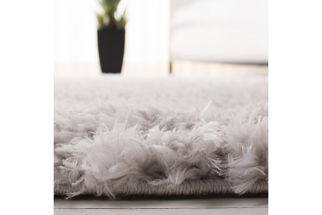 Indulge in retro revival with this sumptuous shag rug. Plush pile is loaded with fun, feel-good texture. Monochromatic hue makes it a tasteful choice for so many spaces.Made of polyester | Machine made | Shag pile | Latex backing; rug pad recommended | Imported | Spot clean only