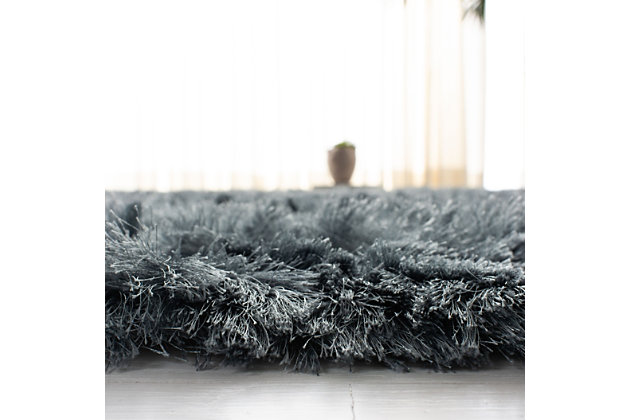 Indulge in retro revival with this sumptuous shag rug. Plush pile is loaded with fun, feel-good texture. Monochromatic hue makes it a tasteful choice for so many spaces.Made of polyester | Hand-tufted; shag pile | Cotton backing; rug pad recommended | Imported | Spot clean only
