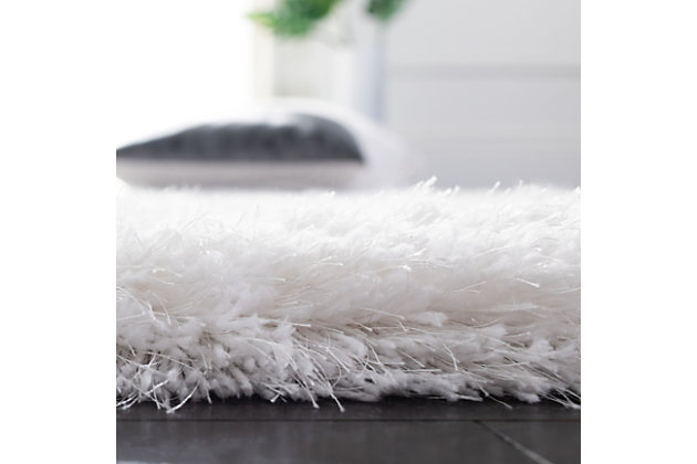 Indulge in retro revival with this sumptuous shag rug. Plush pile is loaded with fun, feel-good texture. Monochromatic hue makes it a tasteful choice for so many spaces.Made of polyester | Hand-tufted; shag pile | Cotton backing; rug pad recommended | Imported | Spot clean only