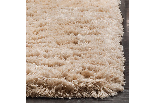Indulge in retro revival with this sumptuous shag rug. Plush pile is loaded with fun, feel-good texture. Monochromatic hue makes it a tasteful choice for so many spaces.Made of  polyester | Machine woven | Shag pile | Woven backing; rug pad recommended | Spot clean | Imported