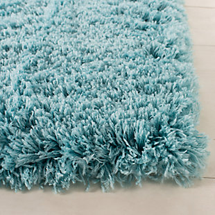 Indulge in retro revival with this sumptuous shag rug. Plush pile is loaded with fun, feel-good texture. Monochromatic hue makes it a tasteful choice for so many spaces.Made of  polyester | Machine woven | Shag pile | Woven backing; rug pad recommended | Spot clean | Imported