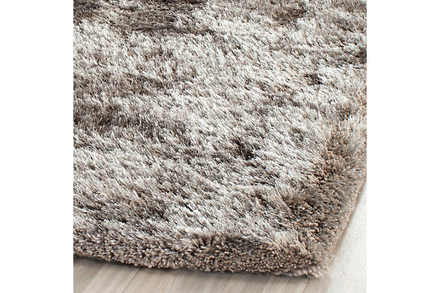 Indulge in retro revival with this sumptuous shag rug. Plush pile is loaded with fun, feel-good texture. Monochromatic hue makes it a tasteful choice for so many spaces.Made of  polyester | Hand-tufted | Shag pile | Woven backing; rug pad recommended | Spot clean | Imported