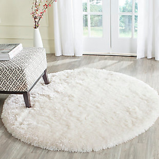 Indulge in retro revival with this sumptuous shag rug. Plush pile is loaded with fun, feel-good texture. Monochromatic hue makes it a tasteful choice for so many spaces.Made of  polyester | Hand-tufted | Shag pile | Woven backing; rug pad recommended | Spot clean | Imported