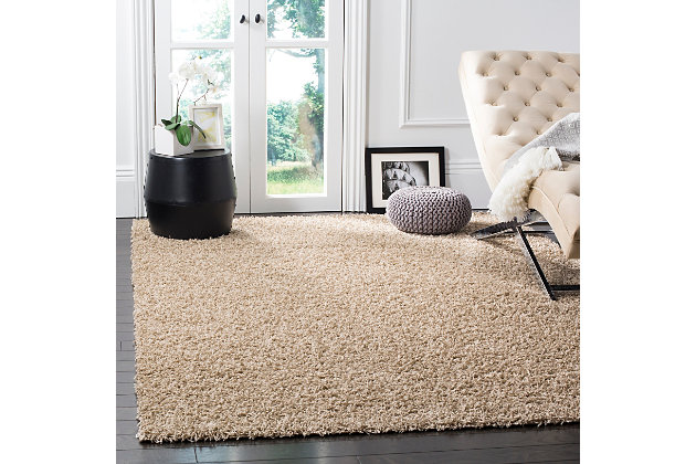 Indulge in retro revival with this sumptuous shag rug. Plush pile is loaded with fun, feel-good texture. Monochromatic hue makes it a tasteful choice for so many spaces.Made of  polypropylene | Machine woven | Shag pile | Jute backing; rug pad recommended | Spot clean | Imported