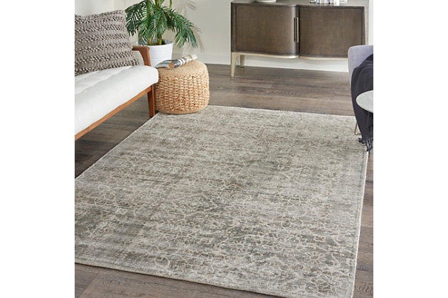 Highly refined and infinitely elegant, this thrilling collection features an alluring array of antique-inspired designs and incandescent color palettes to impart an air of sumptuous sophistication to any interior. Expertly hand loomed from supremely shiny and silky yarns and created with a beautiful tip-sheered loop pile, each resplendent area rug is outstanding in its look and feel. This transitional floral and diamond design gets a contemporary kick thanks to glamorously gradated tones of grey, white, and subtle blue. Hand loomed from splendidly shining threads, this versatile, terrifically-textured area rug is enticingly at home in both traditional and modern settings.100% rayon | 100% rayon | Hand loomed | Tip-sheared loop pile | Low shedding | Indoor only; rug pad recommended | Imported
