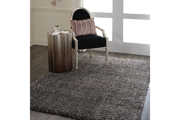 With a shag pile deep enough to lose yourself in, the nourison luxe shag area rug collection brings a warm, luxurious touch to your home, woven on state-of-the-art looms for excellent durability. This collection features sleek solid greys and neutral tones as well as traditional moroccan lattice designs, with plush 2-inch flokati shag pile for comfort that never goes out of style. This exceptionally plush 2-inch-deep flokati shag rug from the nourison luxe shag collection has the look and feel of luxuriously soft sheepskin, and makes a perfect addition  to any casual room setting. Luxurious texture and deep grey color for a warm, soothing accent.100% polyester | 100% polyester | Power loomed | Serged edges | Low shedding | Indoor only; rug pad recommended | Imported