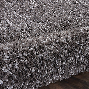 With a shag pile deep enough to lose yourself in, the nourison luxe shag area rug collection brings a warm, luxurious touch to your home, woven on state-of-the-art looms for excellent durability. This collection features sleek solid greys and neutral tones as well as traditional moroccan lattice designs, with plush 2-inch flokati shag pile for comfort that never goes out of style. This exceptionally plush 2-inch-deep flokati shag rug from the nourison luxe shag collection has the look and feel of luxuriously soft sheepskin, and makes a perfect addition  to any casual room setting. Luxurious texture and deep grey color for a warm, soothing accent.100% polyester | 100% polyester | Power loomed | Serged edges | Low shedding | Indoor only; rug pad recommended | Imported