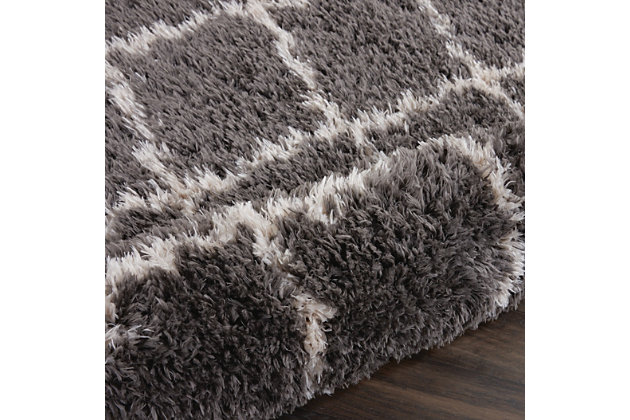 With a shag pile deep enough to lose yourself in, the nourison luxe shag area rug collection brings a warm, luxurious touch to your home, woven on state-of-the-art looms for excellent durability. This collection features sleek solid greys and neutral tones as well as traditional moroccan lattice designs, with plush 2-inch flokati shag pile for comfort that never goes out of style. This exceptionally plush 2-inch-deep shag rug from the nourison luxe shag collection has the look and feel of luxuriously soft sheepskin, and makes a perfect addition to any casual room setting. Luxurious texture and moroccan lattice pattern on deep grey color for a warm, soothing accent.100% polyester | 100% polyester | Power loomed | Serged edges | Low shedding | Indoor only; rug pad recommended | Imported