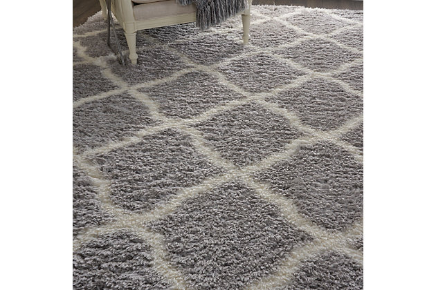 With a shag pile deep enough to lose yourself in, the nourison luxe shag area rug collection brings a warm, luxurious touch to your home, woven on state-of-the-art looms for excellent durability. This collection features sleek solid greys and neutral tones as well as traditional moroccan lattice designs, with plush 2-inch flokati shag pile for comfort that never goes out of style. This exceptionally plush 2-inch-deep shag rug from the nourison luxe shag collection has the look and feel of luxuriously soft sheepskin, and makes a perfect addition to any casual room setting. Luxurious texture and moroccan lattice pattern on pale grey color for a warm, soothing accent.100% polyester | 100% polyester | Power loomed | Serged edges | Low shedding | Indoor only; rug pad recommended | Imported