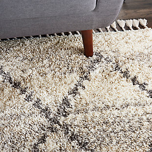 With contemporary hues and clean lines, nourison's oslo collection reflects a scandinavian influence in these plush shag rugs. These thick, inviting rugs feature easy-care fibers with twisted fringe finish for an authentic tribal look and feel, featuring lattice and diamond designs in rich grays and soothing neutral colors. Each rug adds a layer of warmth and welcome to any space in your home. Warm neutral tones of ivory and gray create a subtle mottled background for the lattice grid of this scandinavian tribal rug from nourison's oslo collection. With a look that brings contemporary and ancient styles together, this rug is at home in any decor setting, with easy-care fibers and plush, welcoming shag texture.100% polypropylene | Power loomed | Easy-care fibers | Low shedding | Shag | Indoor only | Imported