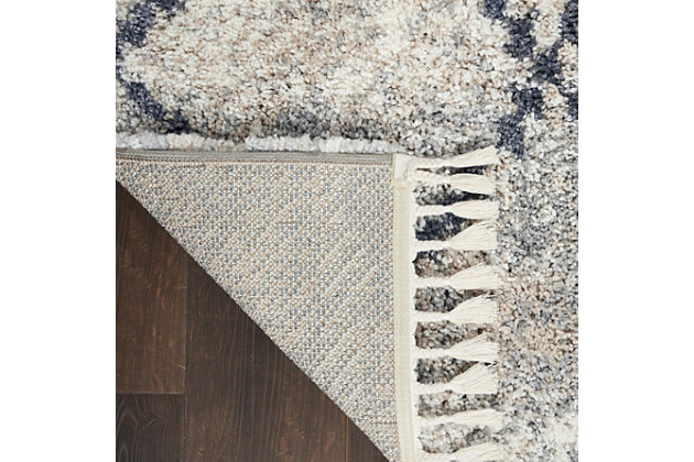 Sleek silvery gray shades create a subtle mottled background for the lattice grid of this scandinavian tribal rug from nourison's oslo collection. With a look that brings contemporary and ancient styles together, this rug is at home in any decor setting, with easy-care fibers and plush, welcoming shag texture.100% polypropylene | Power loomed | Easy-care fibers | Low shedding | Shag | Indoor only | Imported