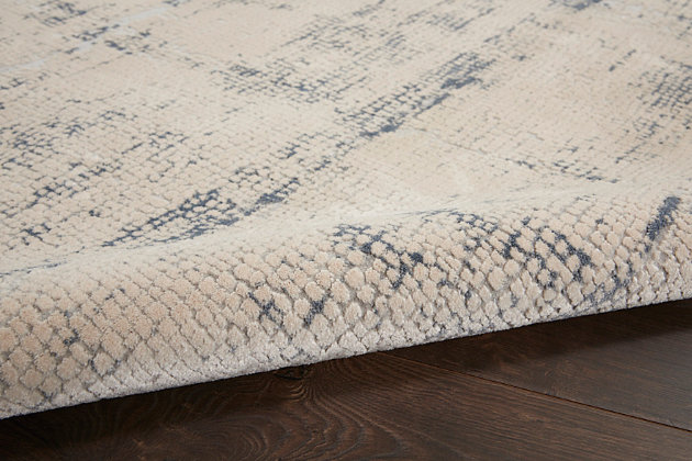 At home in a country cabin or urban loft, the rustic textures collection from nourison blends earthen tones and contemporary abstracts together in beautifully textured modern rugs that are sure to bring a rustic sensibility to any decor. This beautifully carved contemporary rug from the rustic textures collection brings abstract silver, gray, and cream patterns together for a textured look with a smooth, soft feel. High-low pile construction and subtly shifting colors are at home in urban and cabin settings alike.62% polypropylene, 38% polyester | Power loomed | Serged edges | Low shedding | Textured | Indoor only | Imported