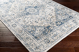 Charm your guests with the floral, lightly-distressed patterns of this elegant rug. Its stunning design infuses traditional style with trendy cool-toned shades. Made in Turkey with a blend of polypropylene and polyester, this piece is great for an entryway or bedroom. Spot or professional cleaning is recommended.90% Polypropylene, 10% Polyester | Machine woven | Imported | No shedding | Spot clean
