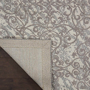 Flowing tendrils give this jacquard-woven area rug a fanciful twist. Muted palette of ivory and silvery gray is the essence of faded romance. Chenille-feel pile tantalizes with cloud-like softness.Made of polyester/cotton/rayon | Machine woven | Cotton backing; rug pad recommended | Imported | Spot clean