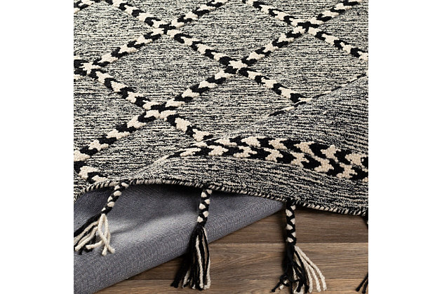 Trendy oversized braided accent tassels and a high-low pile make this an insta-worthy piece that will be the highlight any room. Hand-tufted in India with 100% wool, this global inspired piece with its modern geometric design, is an affordable option but with a priceless wow factor. 100% wool | Hand Tufted | Imported | Minimal Shedding | Spot clean