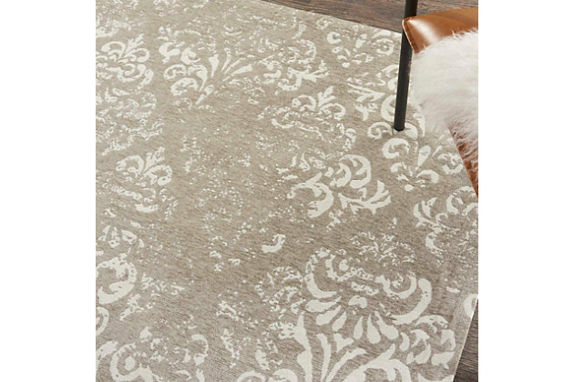 Jacquard-woven in beautiful ivory and gray neutrals, this area rug strikes the perfect balance of drama and refinement. The richly detailed fleurs-de-lis pattern adds a classic finesse that enchants with a subtle antiqued finish. Slender ribbon borders tie the whole look together.Made of polyester/cotton/rayon | Machine woven | Cotton backing; rug pad recommended | Imported | Spot clean