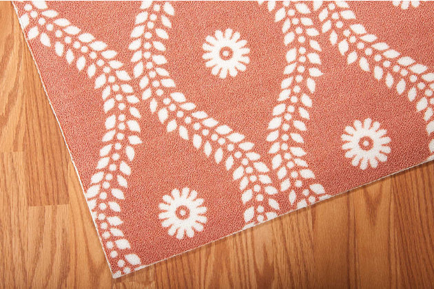 Add some excitement to any surrounding with these magnificent indoor/outdoor rugs. Floral, scrollwork, and animal-skin patterns in vivid color make this a truly eye-catching collection. These versatile rugs are beautiful to look at, soft to walk on, and easy to clean with just a hose. Leafy vines trace sinuous arabesques down a russet field, each curve centered by a fresh blossom. The warm terra-cotta shade is perfect for a summery feel in the home or on the patio. Enjoy its casual luxury in a rug designed for easy living.100% polyester | Power loomed | Serged edges | Low shedding | Easy to clean, simply rinse with a hose | Low pile | Imported